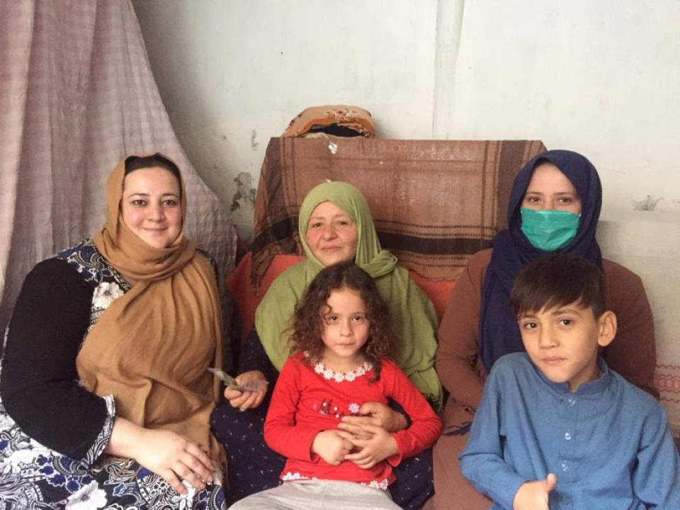 Farida (left) distributing funds for food and housing support in Kabul, Afghanistan.